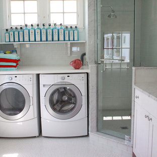Photo of a large coastal l-shaped utility room in Boston with a submerged sink, shaker cabinets, white cabinets, marble worktops, blue walls, ceramic flooring, a side by side washer and dryer, yellow floors and white worktops.