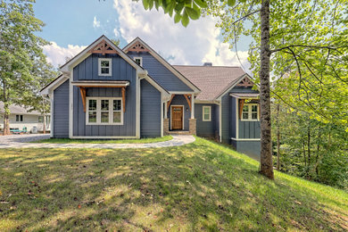 Large arts and crafts blue two-story concrete fiberboard exterior home photo in Atlanta with a shingle roof and a brown roof