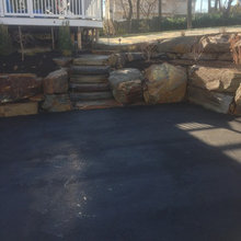 Parking pad retaining wall