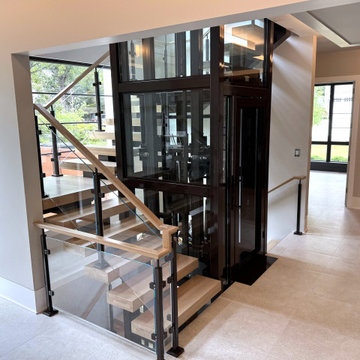 Project #136 | Modern Floating Staircase Encircling Glass Elevator