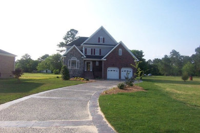 Example of a large classic multicolored three-story mixed siding exterior home design in Other with a shingle roof