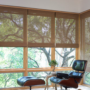 This is an example of a mid-sized asian study room in Houston with purple walls, light hardwood floors and no fireplace.