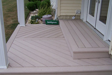 Large elegant side yard deck photo in Other with a roof extension