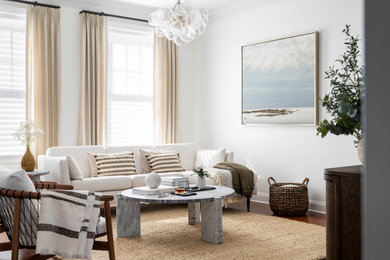 Example of a transitional open concept medium tone wood floor and brown floor living room design in Other with white walls