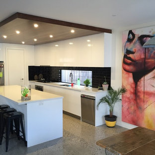 Mid-sized contemporary kitchen pantry pictures - Mid-sized trendy concrete floor kitchen pantry photo in Geelong with an undermount sink, black backsplash, ceramic backsplash and an island