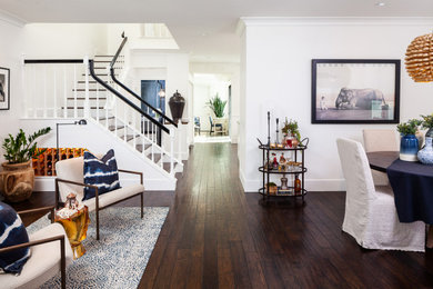Inspiration for a mid-sized eclectic dark wood floor hallway remodel in Orange County with white walls