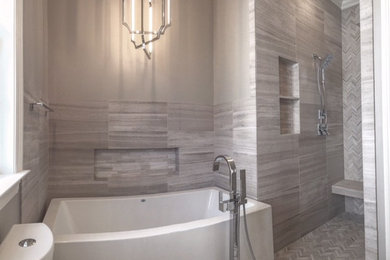 This is an example of a mid-sized contemporary master bathroom in New Orleans with a drop-in tub, an alcove shower, gray tile, white tile, porcelain tile, multi-coloured walls, porcelain floors, multi-coloured floor and an open shower.