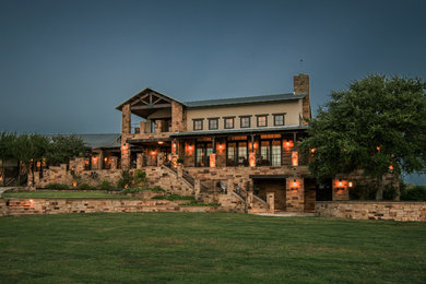 Huge contemporary beige two-story stone exterior home idea in Austin