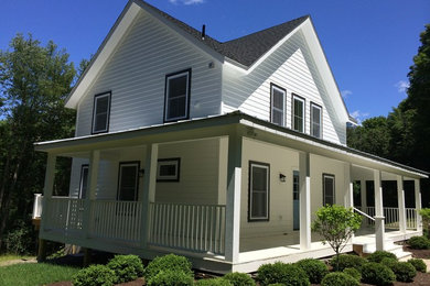 Farmhouse white two-story exterior home idea in New York
