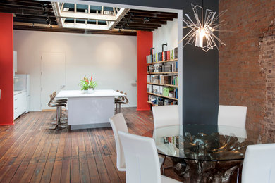 Example of a large transitional single-wall medium tone wood floor and brown floor open concept kitchen design in Atlanta with an undermount sink, flat-panel cabinets, white cabinets, quartzite countertops, white appliances and an island
