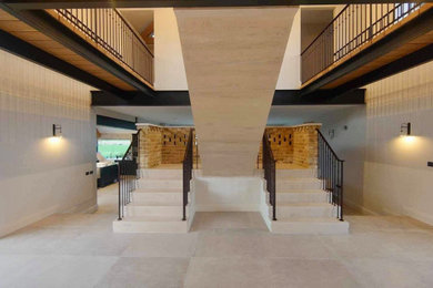 Inspiration for a medium sized modern floating metal railing staircase spindle in Other with travertine treads and travertine risers.