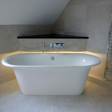 The luxurious freestanding bath is set off with ambient LED lighting.