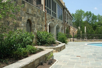 Patio - huge craftsman backyard stone patio idea in Nashville with no cover