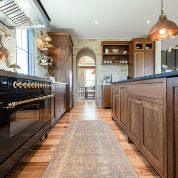 Warm Modern Kitchen with Soapstone Island & Stone Archway