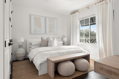 Inspiration for a small coastal guest dark wood floor and brown floor bedroom remodel in Tampa with white walls and no fireplace