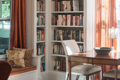 Mid-sized transitional freestanding desk dark wood floor and brown floor home office library photo in Boston with beige walls