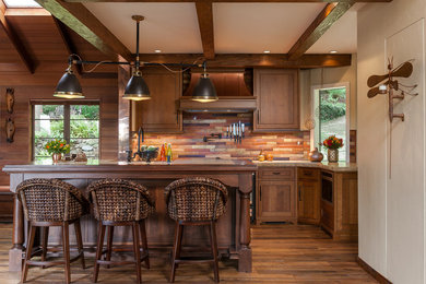 Example of a mid-sized mountain style galley dark wood floor kitchen design in San Francisco with shaker cabinets, dark wood cabinets, an island, slate backsplash and granite countertops