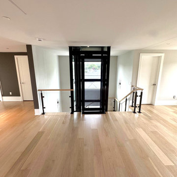 Project #136 | Modern Floating Staircase Encircling Glass Elevator
