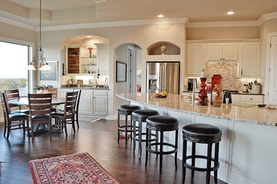 Inspiration for a mid-sized timeless l-shaped dark wood floor eat-in kitchen remodel in Austin with an island, a double-bowl sink, shaker cabinets, white cabinets, granite countertops, beige backsplash, matchstick tile backsplash and stainless steel appliances