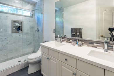 Inspiration for a small transitional 3/4 multicolored tile and glass tile slate floor and black floor walk-in shower remodel in Other with flat-panel cabinets, beige cabinets, a one-piece toilet, white walls, an integrated sink, laminate countertops, a hinged shower door and white countertops