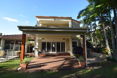 Design ideas for a contemporary backyard deck in Sunshine Coast with a pergola.