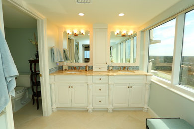 Photo of a mid-sized transitional master bathroom in Miami with raised-panel cabinets, white cabinets, an alcove shower, a one-piece toilet, blue walls, marble floors, a drop-in sink and marble benchtops.