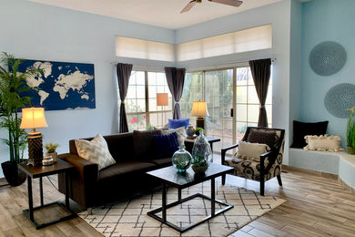 Large trendy open concept porcelain tile and gray floor living room photo in Albuquerque with blue walls, a corner fireplace and a plaster fireplace