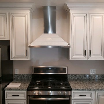 kitchen remodel--white with black glaze cabinets, granite countertop, porcelain