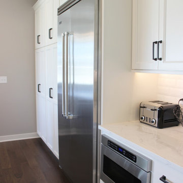 White Cabinet Kitchen With Black Accents and Viking Appliances