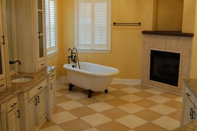 Bathroom - mid-sized traditional master beige tile ceramic tile and beige floor bathroom idea in New Orleans with furniture-like cabinets, white cabinets, yellow walls, a drop-in sink, granite countertops and a hinged shower door