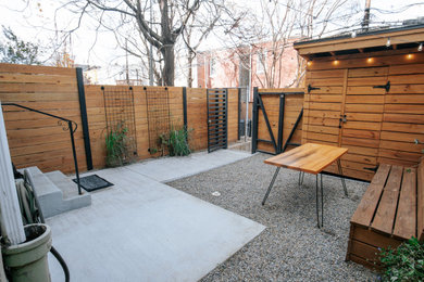 Photo of a small traditional partial sun backyard decomposed granite and wood fence landscaping in DC Metro.