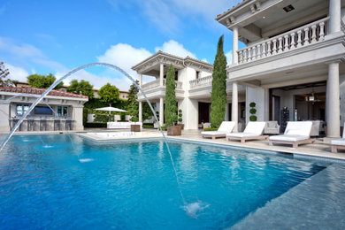 Inspiration for a huge transitional white three-story stucco exterior home remodel in Orange County