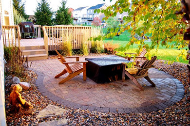 Patio - mid-sized craftsman backyard brick patio idea in Minneapolis with a fire pit and no cover