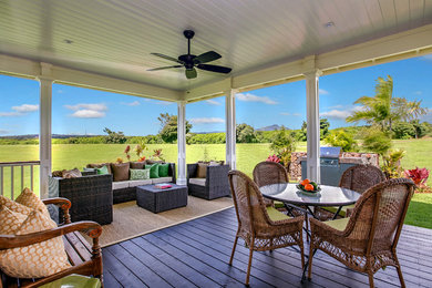 Example of a mid-sized beach style backyard patio kitchen design in Hawaii with decking and a roof extension