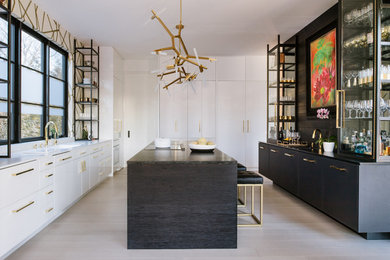 Kitchen - contemporary u-shaped painted wood floor and white floor kitchen idea in DC Metro with flat-panel cabinets, black cabinets, paneled appliances and an island