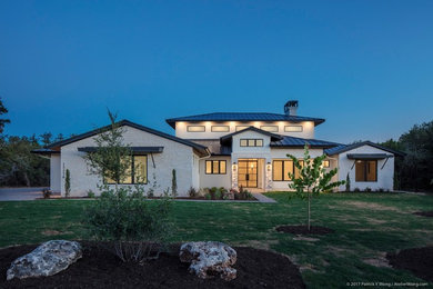 One-story house exterior idea in Austin with a metal roof