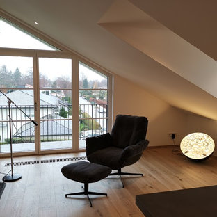 Mid-sized trendy open concept light wood floor home theater photo in Munich with white walls