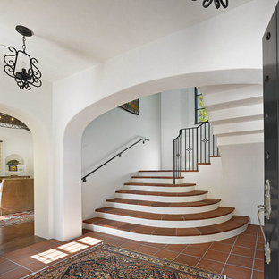 Design ideas for a mediterranean u-shaped metal railing staircase in San Francisco with terracotta treads.