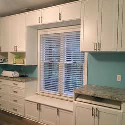 Custom Craft Room with Storage around Window - Storage Cabinets
