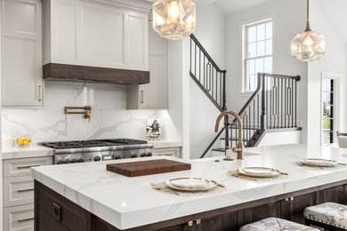 Inspiration for a large transitional l-shaped eat-in kitchen remodel in Detroit with flat-panel cabinets, gray cabinets, quartz countertops, white backsplash, quartz backsplash, stainless steel appliances, an island and white countertops