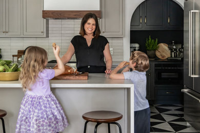 Mid-sized elegant u-shaped cement tile floor and multicolored floor eat-in kitchen photo in Philadelphia with an undermount sink, shaker cabinets, gray cabinets, quartz countertops, beige backsplash, ceramic backsplash, stainless steel appliances, a peninsula and white countertops