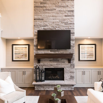 Living Room Remodel Featuring a Ledgestone Fireplace + Cabinetry + Shaw Coretec