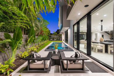 Inspiration for a modern backyard tile patio remodel in Miami