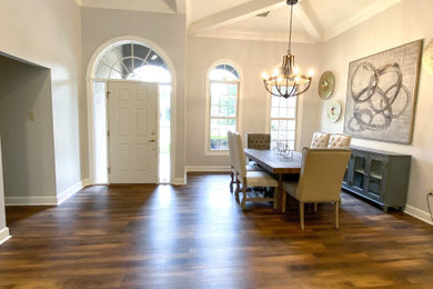 Transitional laminate floor and brown floor kitchen/dining room combo photo in Other with gray walls