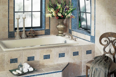 Example of a mid-sized classic master beige tile, blue tile and stone tile travertine floor and beige floor alcove bathtub design in Other with beige walls