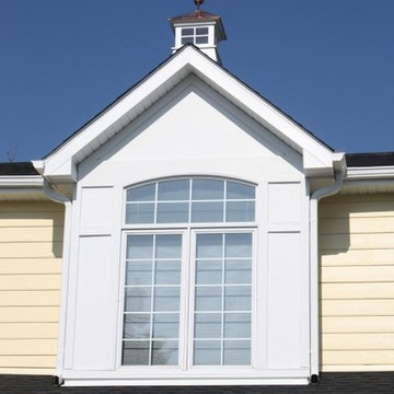 Cape Cod Style: Yellow Siding, White Trim, Black Shutters, Red Door, Roof Cupola
