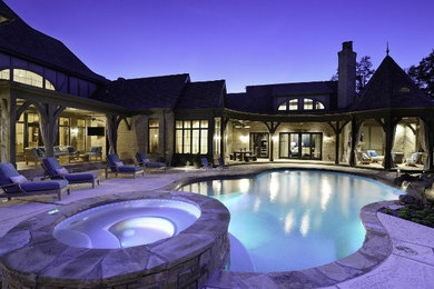 Inspiration for a mid-sized timeless backyard concrete and kidney-shaped hot tub remodel in St Louis