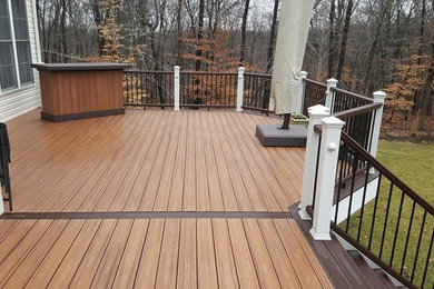 Example of a mid-sized classic backyard deck design in Baltimore with no cover