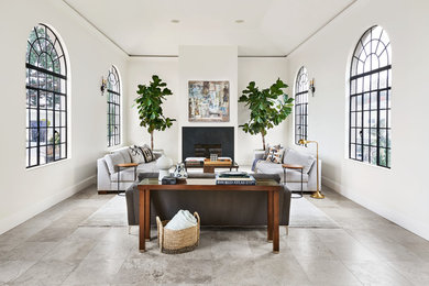 Inspiration for a mediterranean living room in Portland with white walls, a standard fireplace and grey floor.