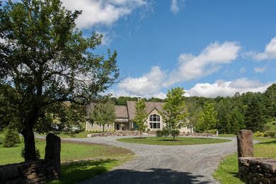 Inspiration for a large cottage green two-story wood exterior home remodel in Burlington with a mixed material roof